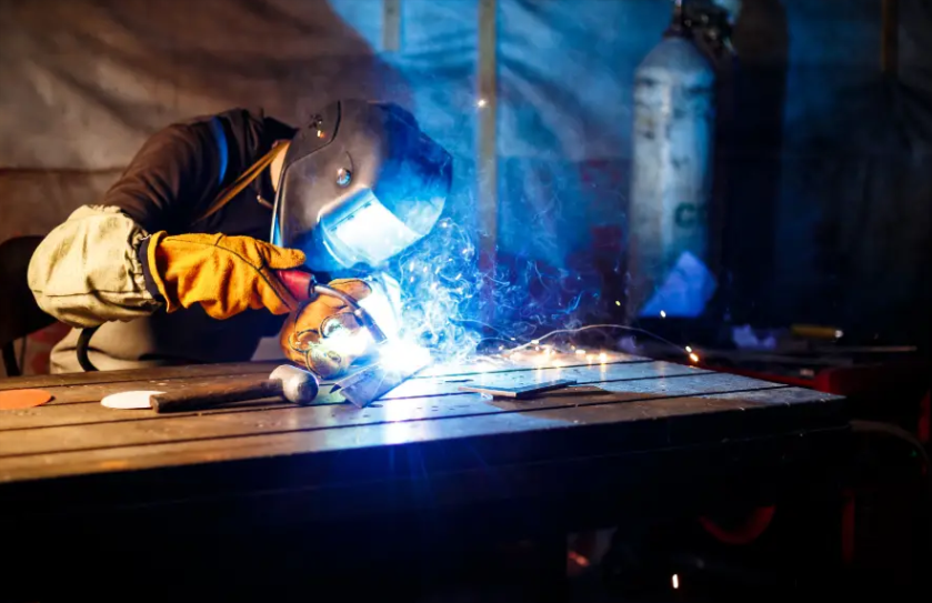 Welder at work with arc sparks — welding supplies and consumables available at Holmes Auto Supply in Decatur, TX